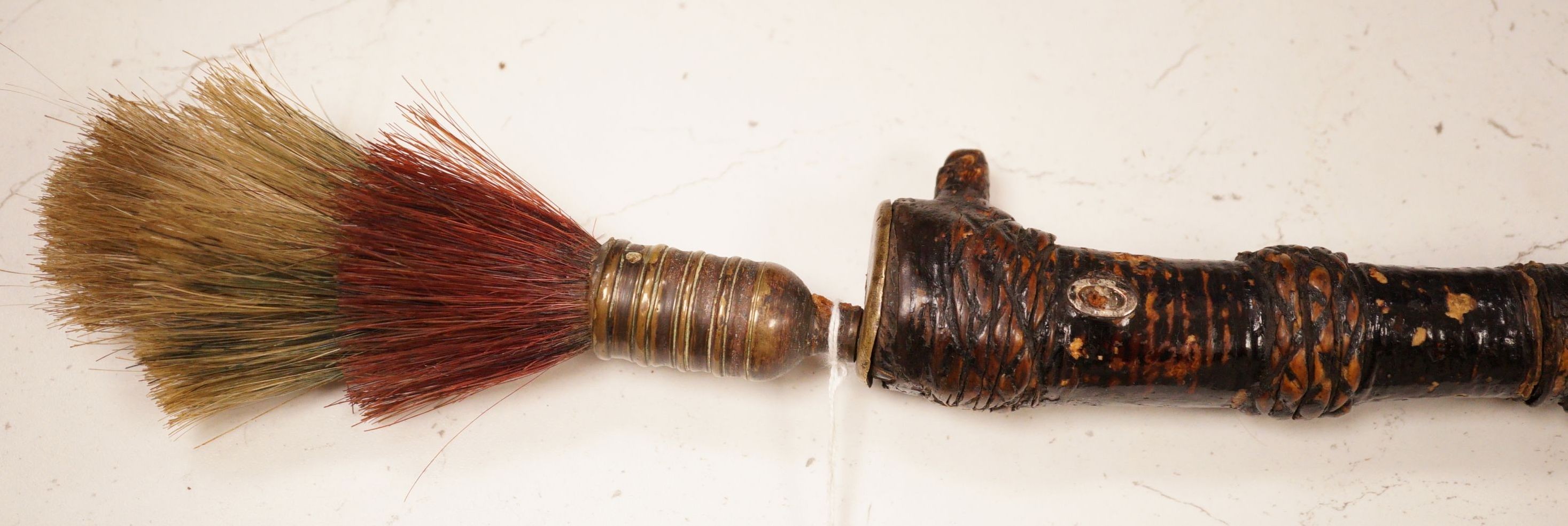 A ceremonial sword stick with removable brush end